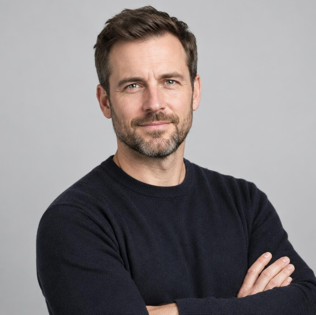 Studio portrait of a white British man with a beard, professional headshot